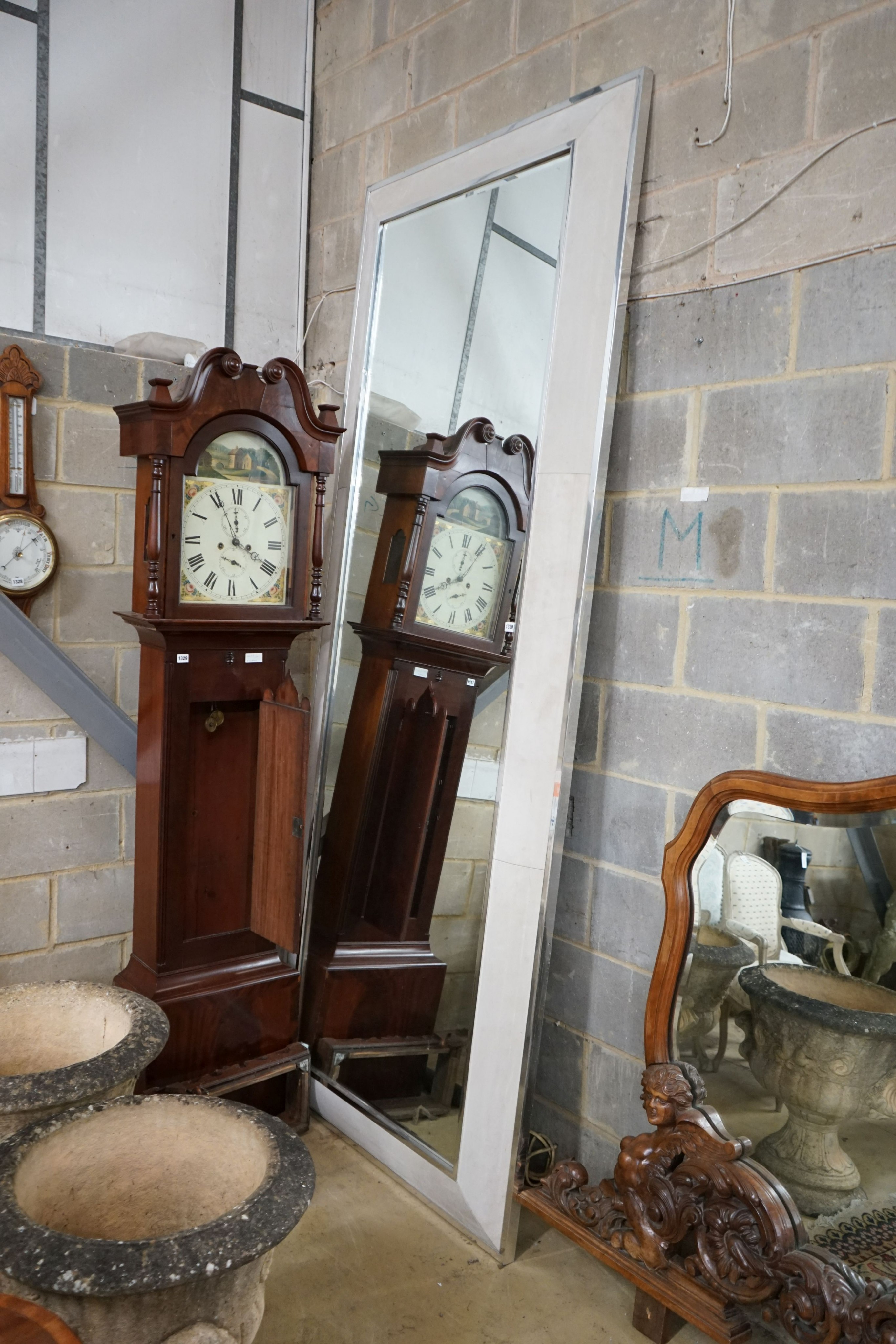 A large rectangular bevelled wall mirror with suede and chrome border, width 110cm, height 280cm